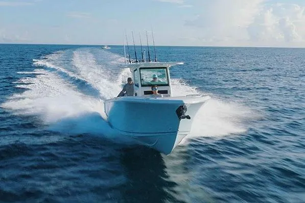 Slide: The Image of Manufacturer Provided Image: 2026 Sailfish 312 CC boat cruising on open ocean waters. - 1