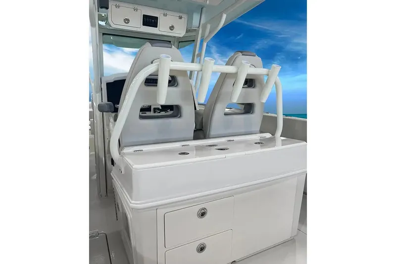 Slide: The Image of Manufacturer Provided Image: 2026 Sailfish 312 CC boat interior with dual seats and storage, under a clear blue sky. - 7