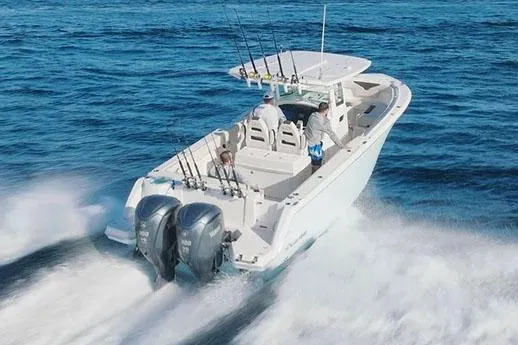 Slide: The Image of Manufacturer Provided Image: 2026 Sailfish 312 CC boat cruising on open water, equipped with dual engines. - 2
