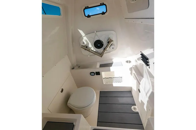 Slide: The Image of Manufacturer Provided Image: Interior of 2026 Sailfish 312 CC boat featuring a compact bathroom setup. - 14