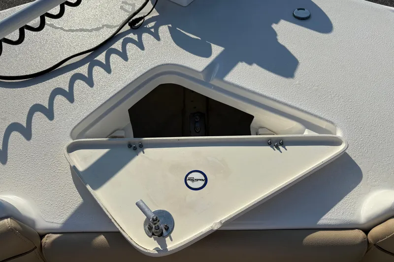Slide: The Image of Open storage compartment on 2019 NauticStar 231 Hybrid boat deck. - 26
