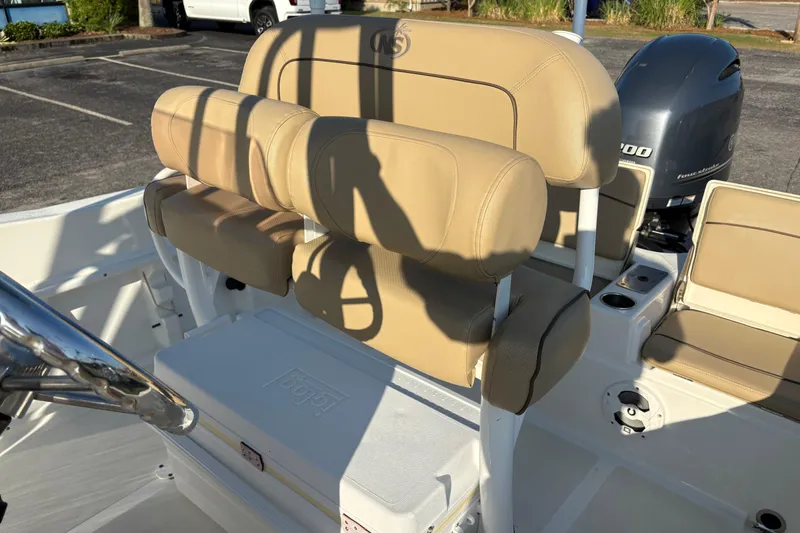 Slide: The Image of 2019 NauticStar 231 Hybrid boat interior with tan seating and Yamaha outboard motor. - 13
