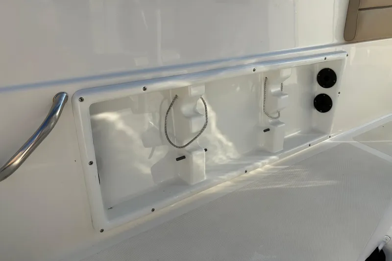 Slide: The Image of 2019 NauticStar 231 Hybrid boat interior detail with storage compartments and fixtures. - 10