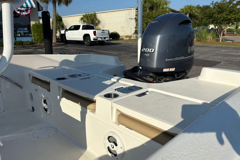 Slide: The Image of 2019 NauticStar 231 Hybrid boat with Yamaha 200 four-stroke engine in a sunny parking lot. - 7