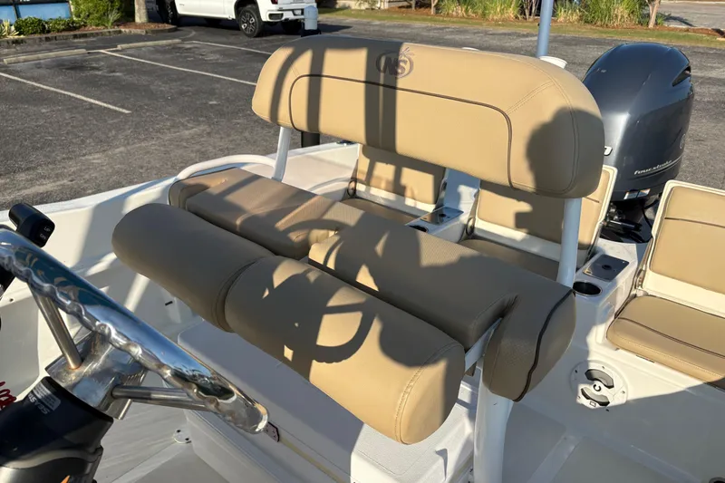 Slide: The Image of 2019 NauticStar 231 Hybrid boat interior with tan seating and steering wheel. - 12