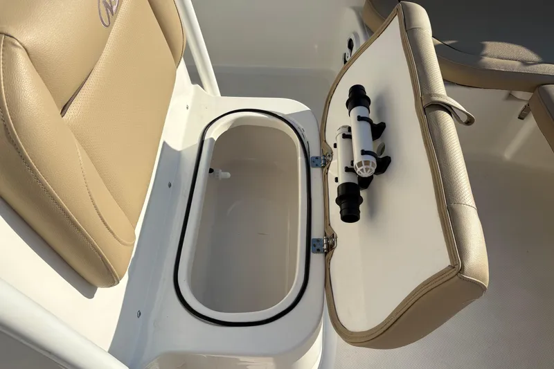 Slide: The Image of 2019 NauticStar 231 Hybrid boat seat with open storage compartment and rod holder. - 24