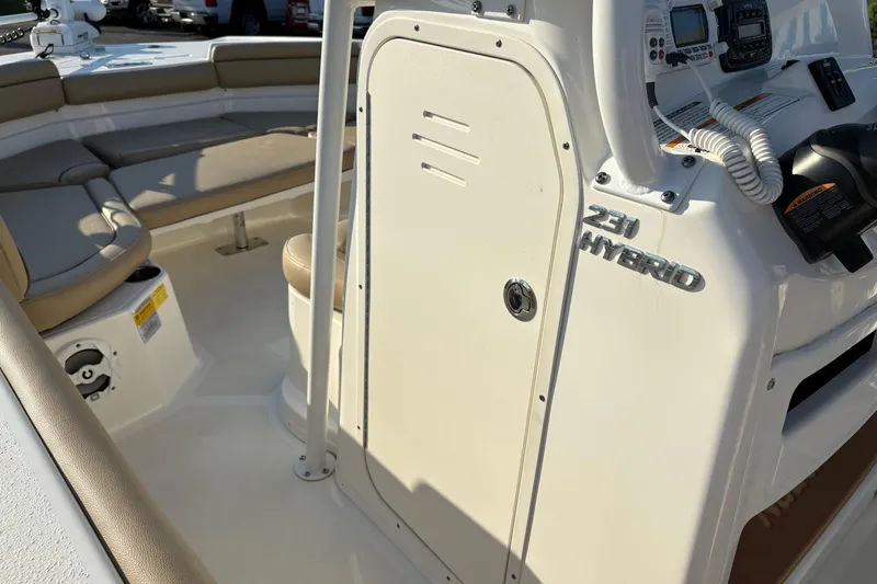 Slide: The Image of 2019 NauticStar 231 Hybrid boat interior with seating and control panel. - 20