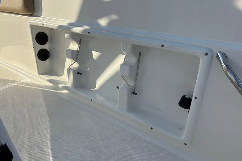Slide: The Image of 2019 NauticStar 231 Hybrid boat interior detail with storage compartments and fixtures. - 9