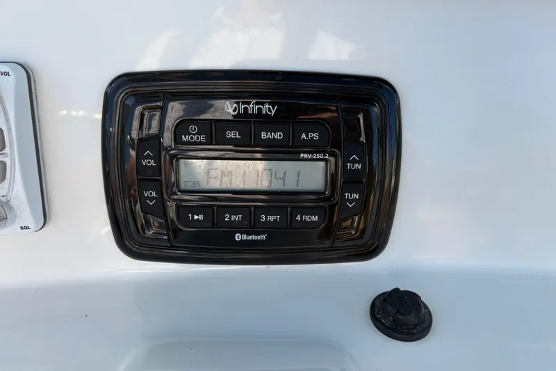 Slide: The Image of Infinity stereo system on 2019 NauticStar 231 Hybrid boat dashboard. - 16