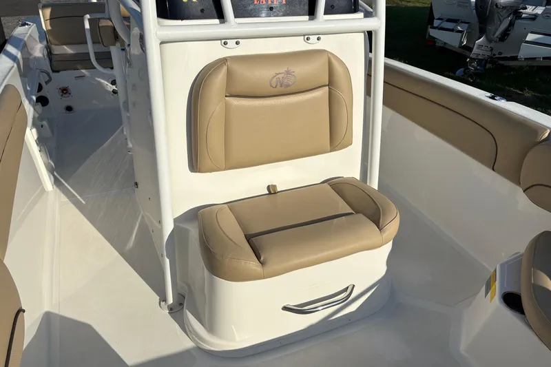 Slide: The Image of 2019 NauticStar 231 Hybrid boat interior with tan seating and white console. - 23