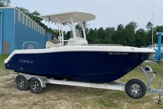 The Image of 2017 Robalo R222 Center Console boat on trailer, parked outdoors. - 0