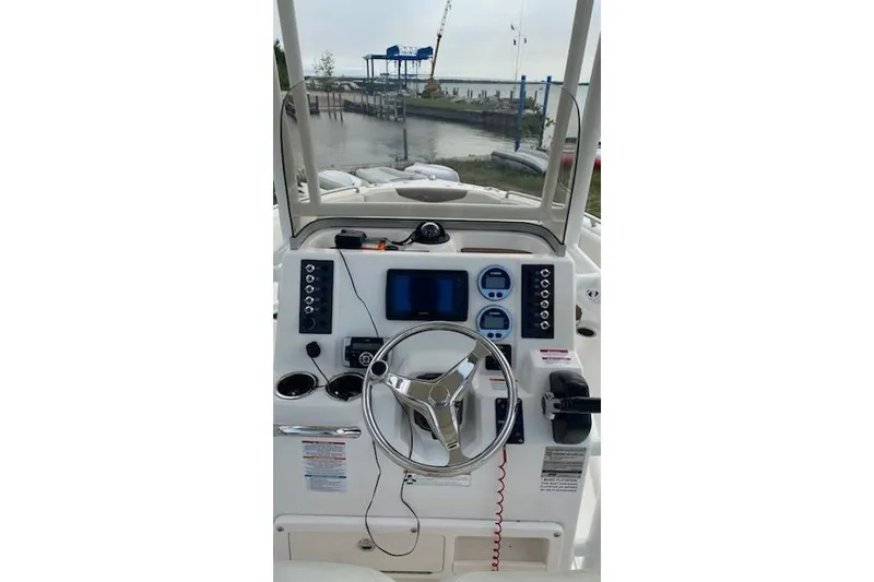 Slide: The Image of 2017 Robalo R222 Center Console boat dashboard with steering wheel and navigation controls. - 5