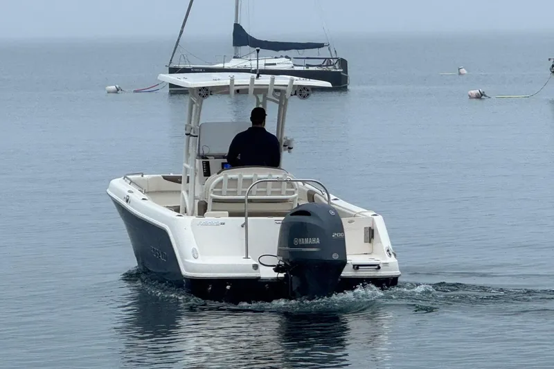 Slide: The Image of 2017 Robalo R222 Center Console boat with Yamaha engine on calm water. - 3