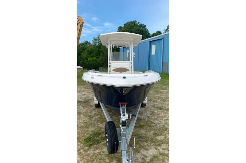 Slide: The Image of 2017 Robalo R222 Center Console boat on trailer, parked outdoors. - 4