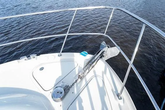 Slide: The Image of 2006 Sea Ray 580 Sedan Bridge bow with anchor, overlooking calm water. - 42
