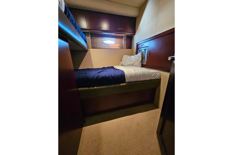 Slide: The Image of Cozy cabin interior of 2006 Sea Ray 580 Sedan Bridge yacht with bed and porthole. - 33