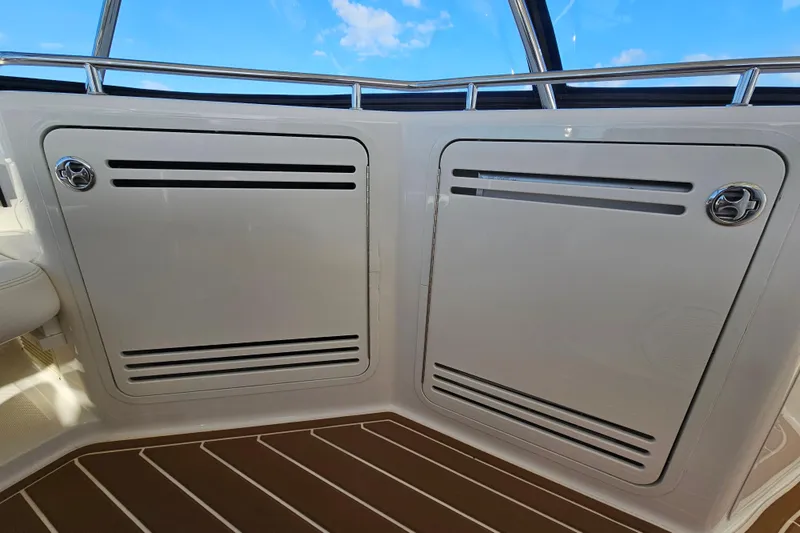Slide: The Image of 2006 Sea Ray 580 Sedan Bridge interior with sleek white paneling and stainless steel accents. - 14