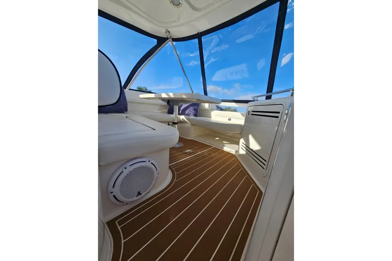 Slide: The Image of Interior view of 2006 Sea Ray 580 Sedan Bridge with sleek seating and wooden flooring. - 11