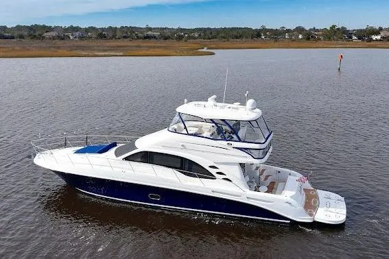 Slide: The Image of 2006 Sea Ray 580 Sedan Bridge yacht cruising on calm waters. - 2