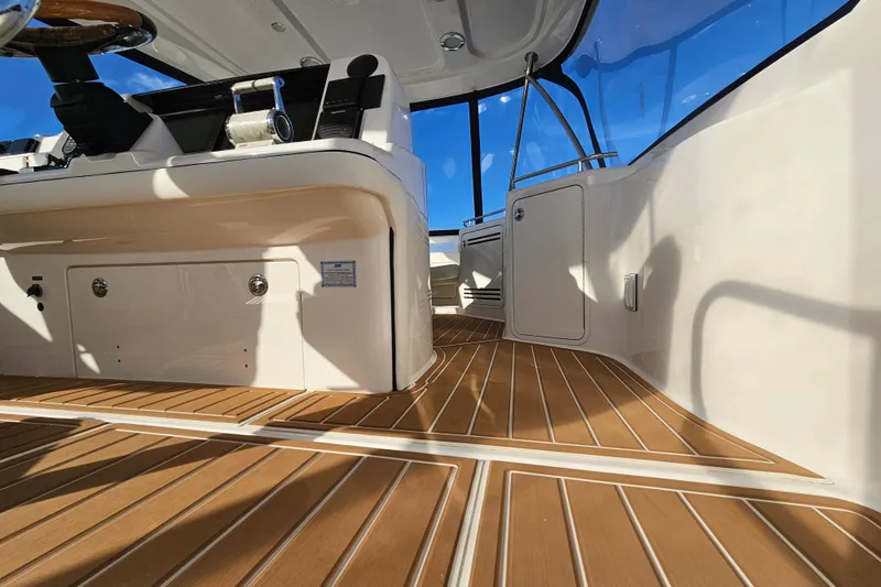 Slide: The Image of Interior view of 2006 Sea Ray 580 Sedan Bridge with sleek wooden flooring. - 13