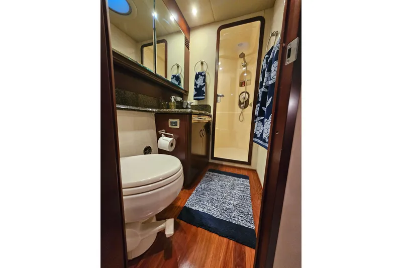 Slide: The Image of Luxurious bathroom in 2006 Sea Ray 580 Sedan Bridge yacht with elegant wood flooring. - 34