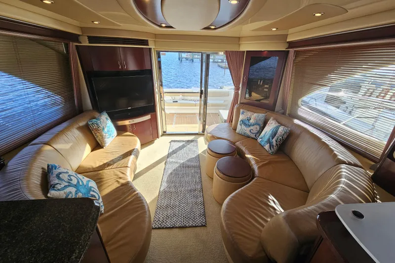 Slide: The Image of Luxurious interior of 2006 Sea Ray 580 Sedan Bridge yacht with leather seating and waterfront view. - 23
