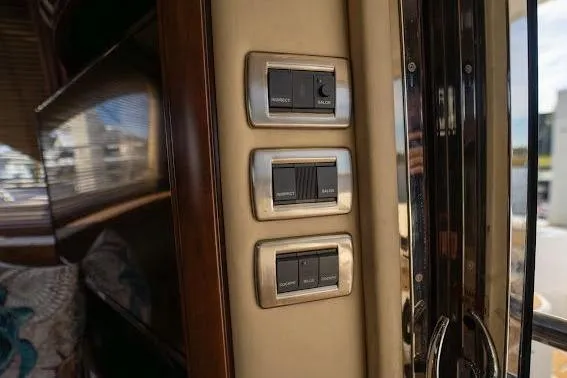Slide: The Image of Control panel inside 2006 Sea Ray 580 Sedan Bridge yacht, featuring modern switches. - 41