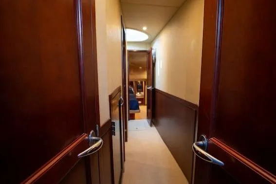 Slide: The Image of Hallway inside 2006 Sea Ray 580 Sedan Bridge yacht with wooden doors and elegant design. - 28