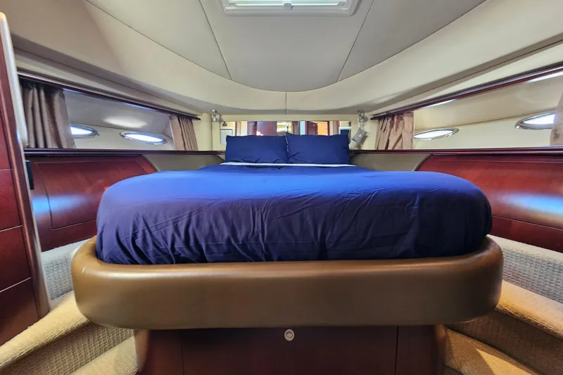 Slide: The Image of Luxurious bedroom interior of 2006 Sea Ray 580 Sedan Bridge yacht with elegant wood finishes. - 35