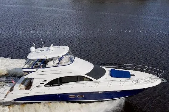 Slide: The Image of 2006 Sea Ray 580 Sedan Bridge yacht cruising on open water, showcasing sleek design and luxury. - 5