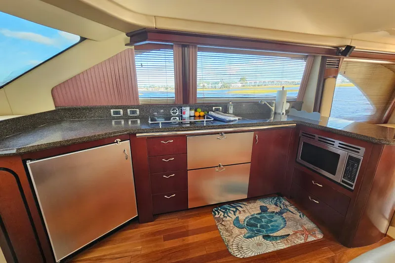Slide: The Image of Luxurious kitchen interior of 2006 Sea Ray 580 Sedan Bridge yacht with modern appliances. - 26