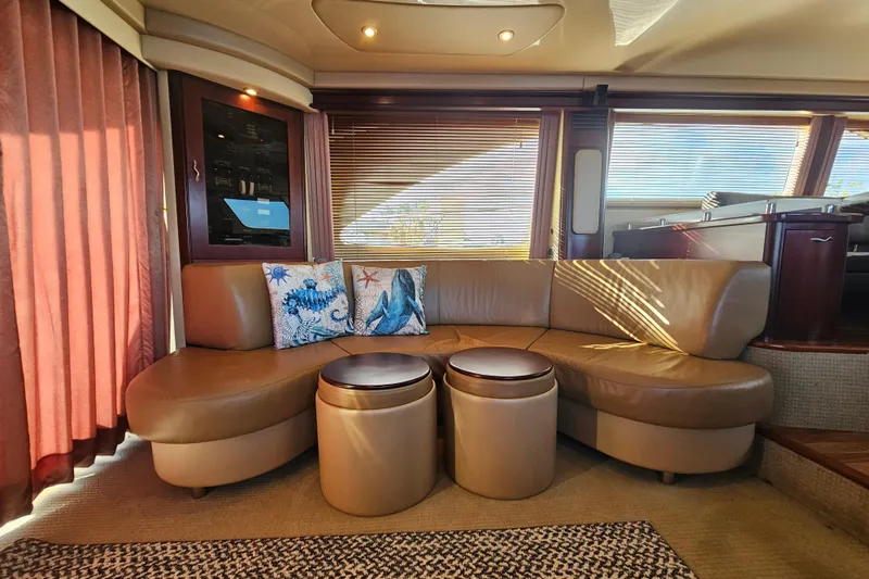Slide: The Image of Luxurious interior of 2006 Sea Ray 580 Sedan Bridge with leather seating and nautical decor. - 27