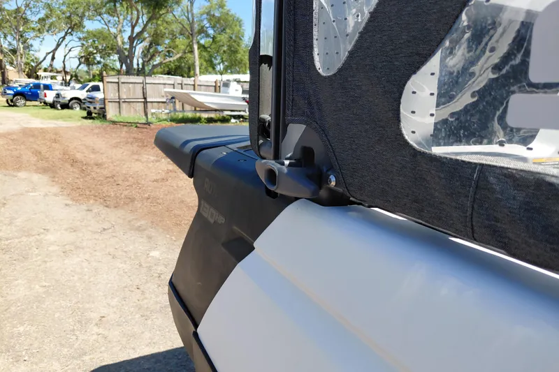 Slide: The Image of 2024 Sea-Doo Switch Cruise 18 side view with protective cover in outdoor setting. - 39