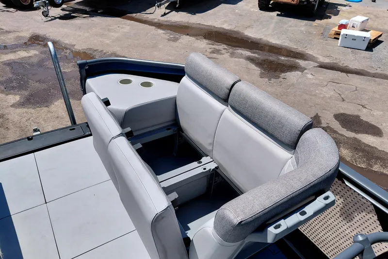 Slide: The Image of 2024 Sea-Doo Switch Cruise 18 boat interior with gray seating and cup holders. - 10