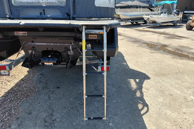 Slide: The Image of 2024 Sea-Doo Switch Cruise 18 with rear ladder and trailer, parked on concrete. - 37
