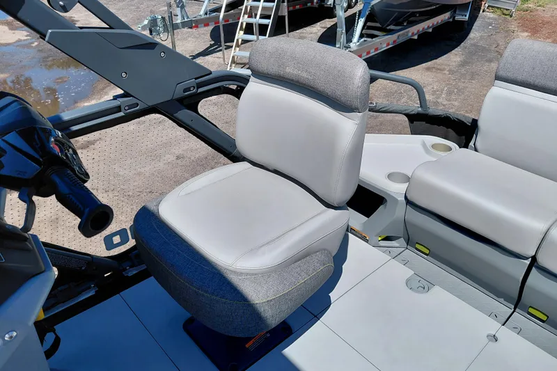 Slide: The Image of 2024 Sea-Doo Switch Cruise 18 interior seating with steering console and cup holders. - 24