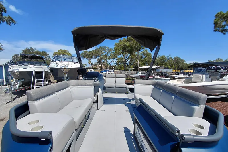 Slide: The Image of 2024 Sea-Doo Switch Cruise 18 pontoon boat with spacious seating and canopy in a marina. - 8