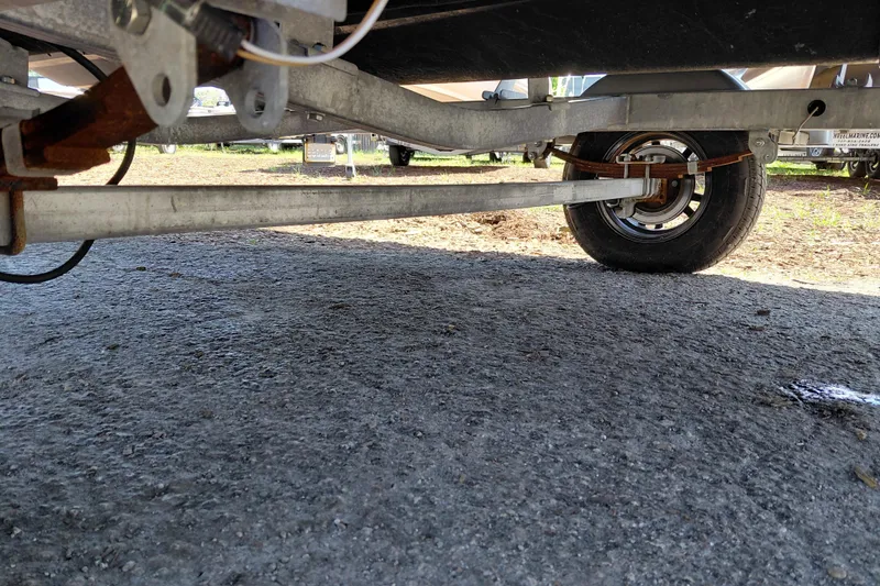 Slide: The Image of Underneath view of a 2024 Sea-Doo Switch Cruise 18 trailer, showing wheel and suspension. - 40