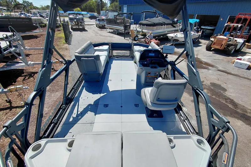 Slide: The Image of 2024 Sea-Doo Switch Cruise 18 pontoon boat interior with seating and steering console. - 32