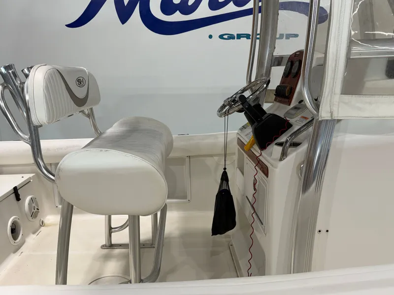 Slide: The Image of The image shows the cockpit of a Sea Hunt ULTRA 21 boat with a white seat and steering. - 10