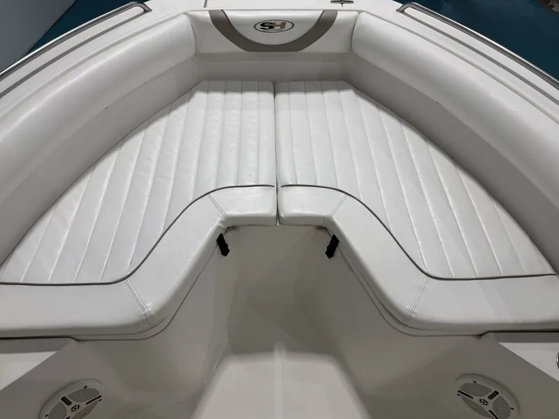 Slide: The Image of The image shows the bow area of a Sea Hunt ULTRA 21 boat with white upholstery. - 18