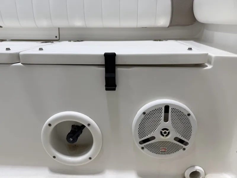 Slide: The Image of Close-up of a white boat deck with speaker and storage compartment. - 22