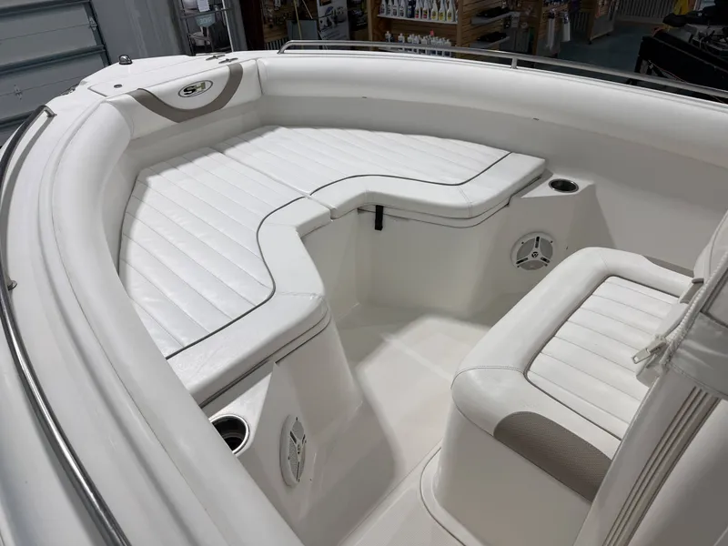 Slide: The Image of The image shows the bow area of a 2010 Sea Hunt ULTRA 21 boat with white upholstery. - 17