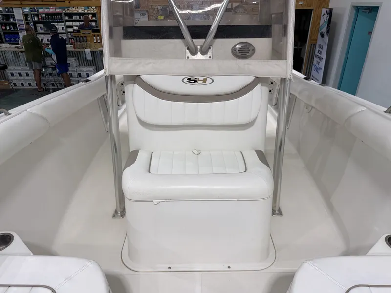 Slide: The Image of The image shows the cockpit of a 2010 Sea Hunt ULTRA 21 boat. - 19