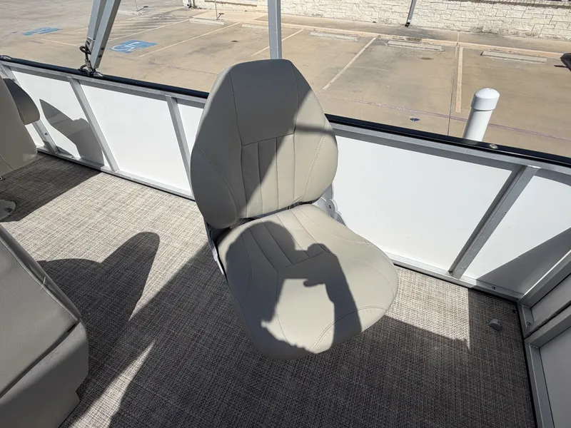 Slide: The Image of A single gray boat seat on a carpeted floor, surrounded by white walls. - 32
