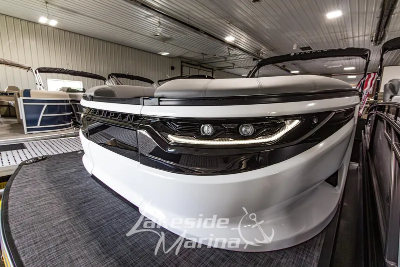 Slide: The Image of 2026 Godfrey Sanpan 2700 MTF pontoon boat in showroom, featuring sleek design and modern lighting. - 11