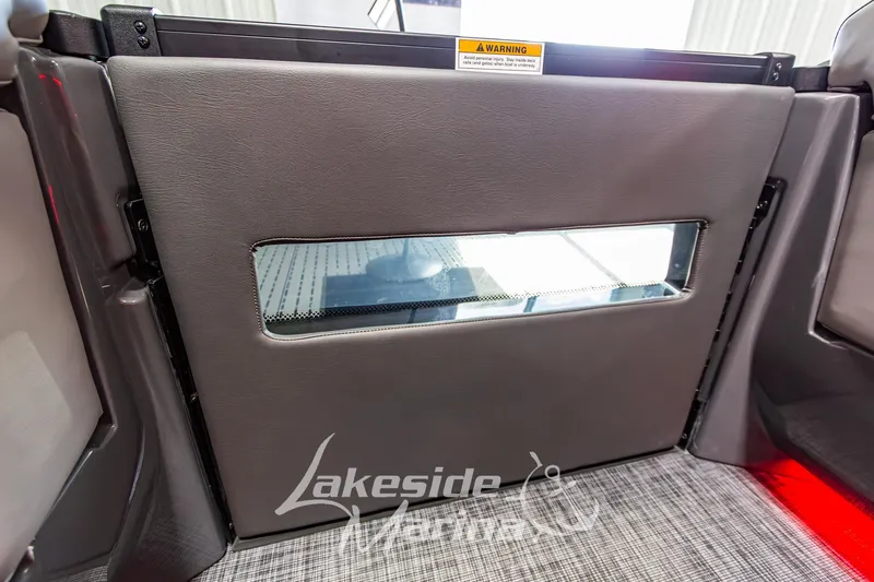 Slide: The Image of 2026 Godfrey Sanpan 2700 MTF boat interior with padded door and window. - 24