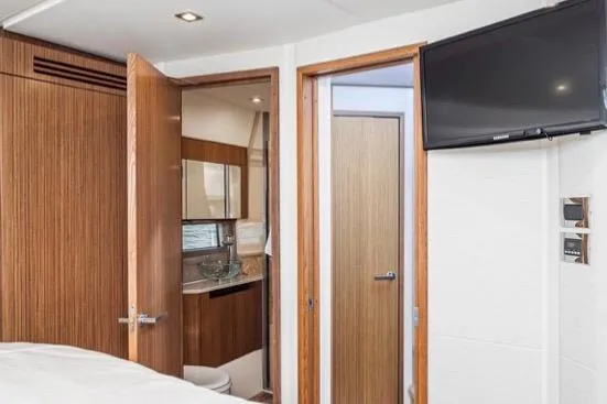 Slide: The Image of Interior of 2017 Sea Ray 460 Sundancer yacht with ensuite head and TV. - 20