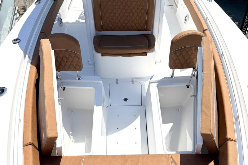 Slide: The Image of 2027 Sea Hunt Ultra 275 SE boat interior with brown cushioned seating and storage compartments. - 26