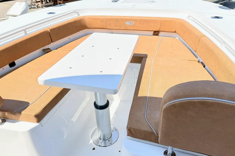 Slide: The Image of Interior seating area of 2027 Sea Hunt Ultra 275 SE boat with table. - 28
